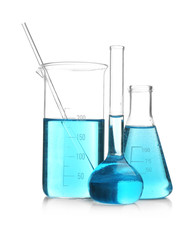 Laboratory glassware with blue samples on white background