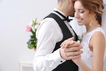 Cute wedding couple dancing at home