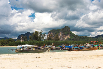 Fototapeta na wymiar Sea, long tail boats, yachts and tropical forest.
