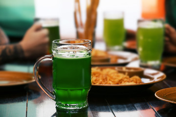 Mug with cold beer on table in pub
