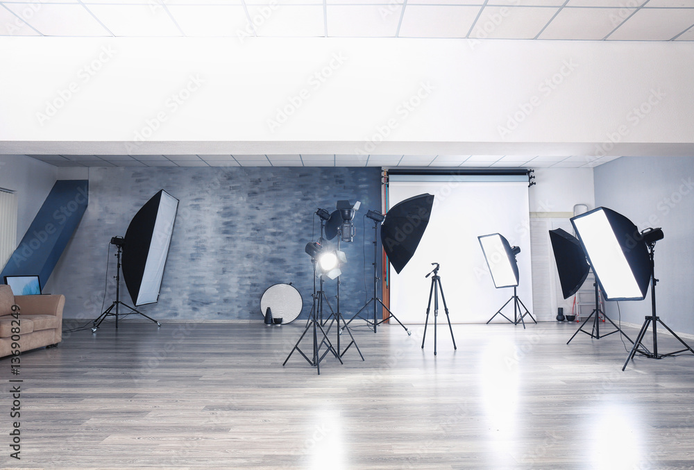 Wall mural Empty photo studio with lighting equipment