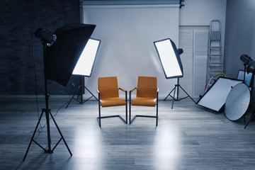 Photo studio with modern interior and lighting equipment