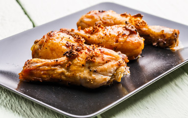 Roasted chicken on black plate