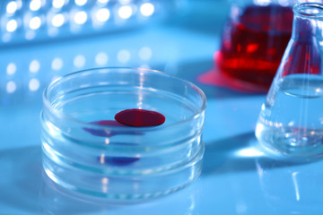 Chemical glassware with blood on blurred background