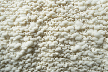 Fototapeta na wymiar White knitted woolen fabric.