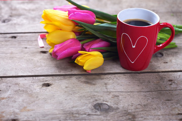 Fototapeta na wymiar Colorful tulips and red cup of coffee