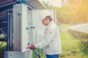 engineer working on checking and maintenance equipment at green energy solar power plant