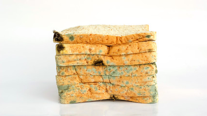 Bread moldy on a white background.