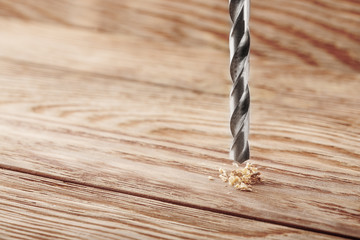metal drill bit make holes in wooden board with expressive texture