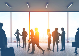 Business people silhouettes in an office hall