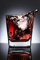 Glass of whiskey with ice on a black background