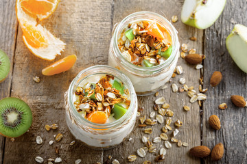 Yogurt, granola and fruits in a jars for delicious breakfast. Traditional American healthy food. Top view Instagram style photo.
