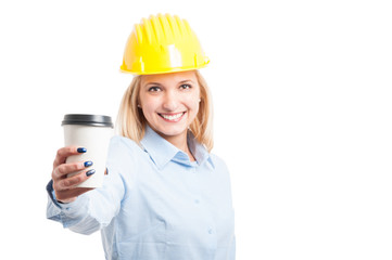 Selective focus of woman engineer showing coffee to go cup