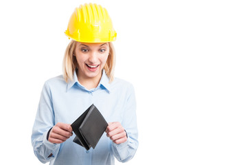 Woman engineer wearing helmet looking happy at wallet
