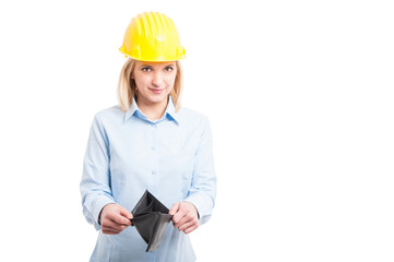 Female engineer wearing helmet showing empty wallet