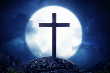 Wooden crosses standing on rock hill with moonlight