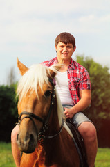Obraz premium young in shape man on a horse
