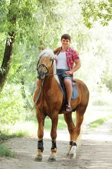 Foto op Canvas young in shape man on a horse © lanarusfoto