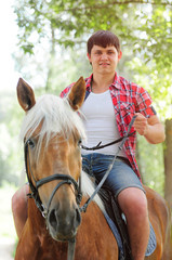 young in shape man on a horse