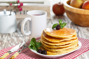 Homemade pancakes with honey and berry fruit. Closeup, selective focus.