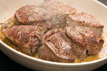 Meat steaks on frying pan