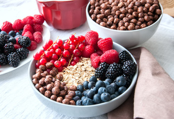 Fresh berries, chocolate balls, and oat granola in a big bowl