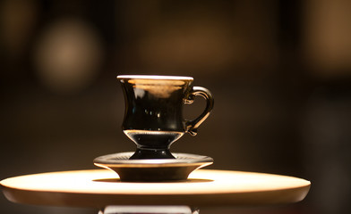 Retro cup of coffee on a wooden plate