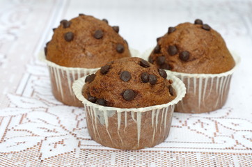 Muffins with chocolate in paper cups on the table