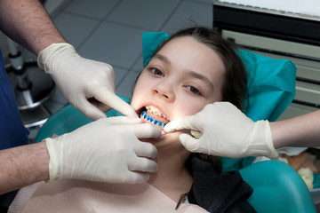 Girl by her dentist