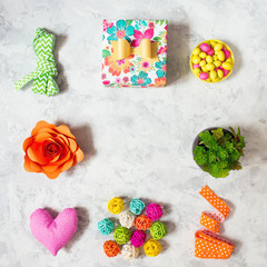 Spring colorful decoration:  envelope, candy, flowers, gift, ribbons, heart,  succulents  and other  other accessories with copy space. Flat lay stylish set.