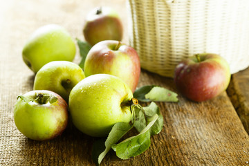 Fresh apples with green leaves