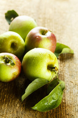 Fresh apples with green leaves