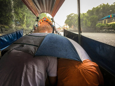 Monsoon rain on a long tail boat - Bangkok river