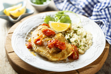 Trout, cooked with smoked paprika, tomatoes and couscous