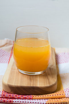 Fresh orange juice on wooden board. Country style photo