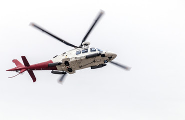 Airborn Helicopter Isolated Against White Overcast Sky