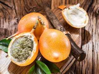 Granadilla fruits on the wooden table.