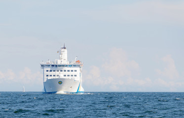 Passenger ferry, rocky coastline and blue sea