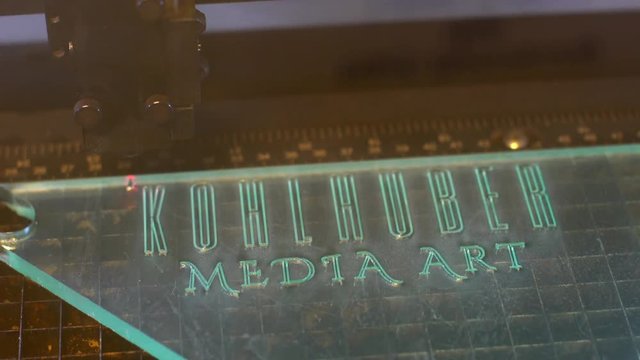 Lasercutter cutting out logo