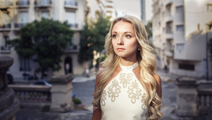 Portrait of beautiful blonde girl in the old city