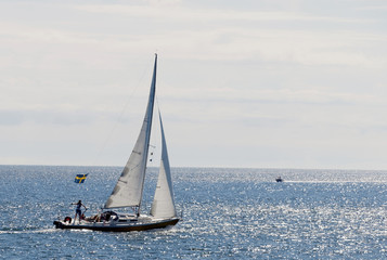 Sailboat on the glittering blue sea