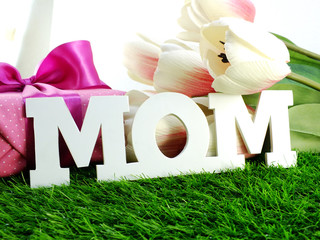 close up of text mom word copy with gift and fllower