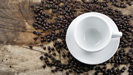 Dark roasting coffee beans put on a wood table.