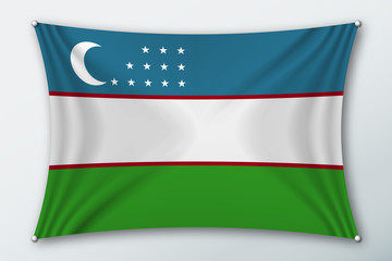 Obraz premium Uzbekistan national flag. Symbol of the country on a stretched fabric with waves attached with pins. Realistic vector illustration.