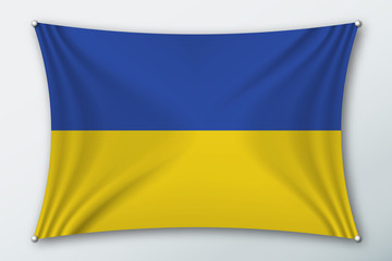 Ukraine national flag. Symbol of the country on a stretched fabric with waves attached with pins. Realistic vector illustration.