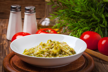 Fried cabbage greens and onion in wooden table.