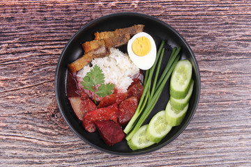 Jasmine rice with meat and boiled egg topped red sweet sauce .