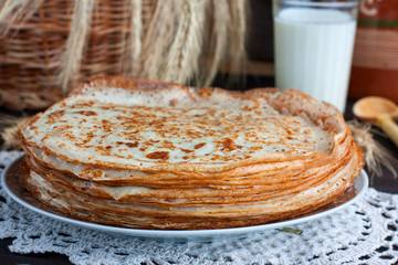 Pancakes on the table with a lace napkin, selective focus