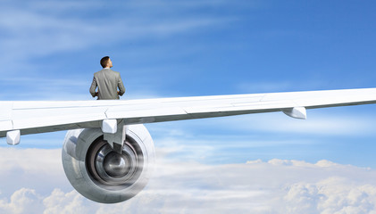 On wing of flying airplane . Mixed media
