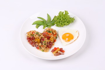 Chinese sausage fried rice and sunny egg in heart shapes.